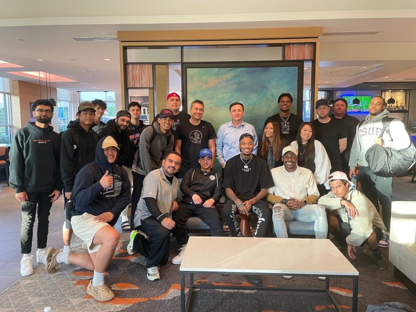The Ballislife team gathers around a table.