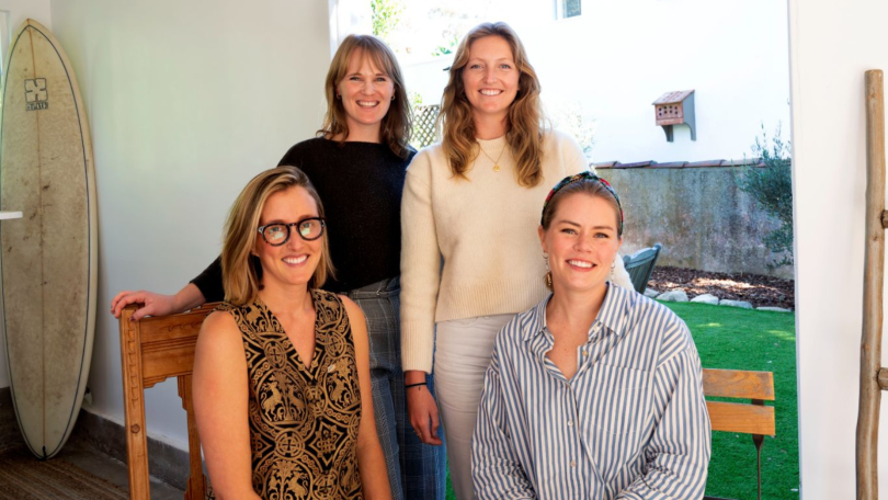 The four members of Beni's executive team pose together for a photo indoors.