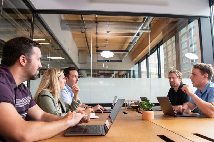 Center team members meet in their offices. 
