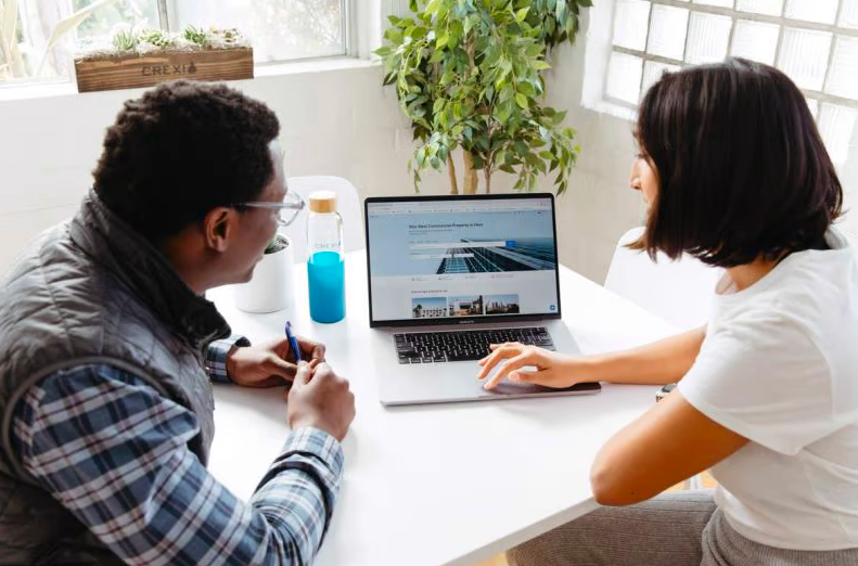 coworkers looking at a laptop together