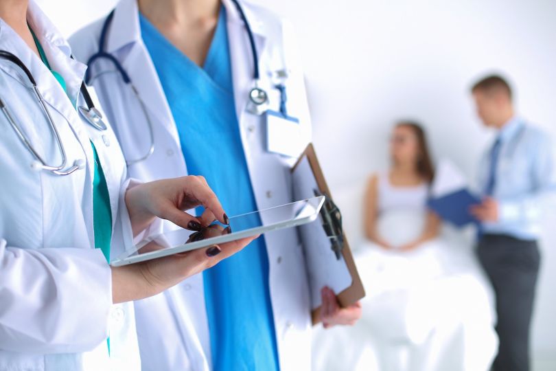 An image depicting medical professionals conversing is shown.