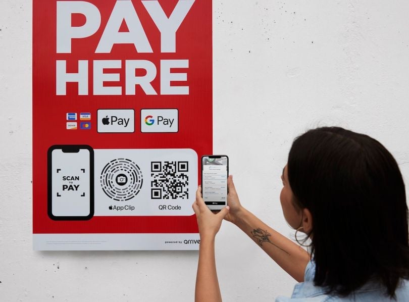 A woman uses FLASH's technology to pay for parking.