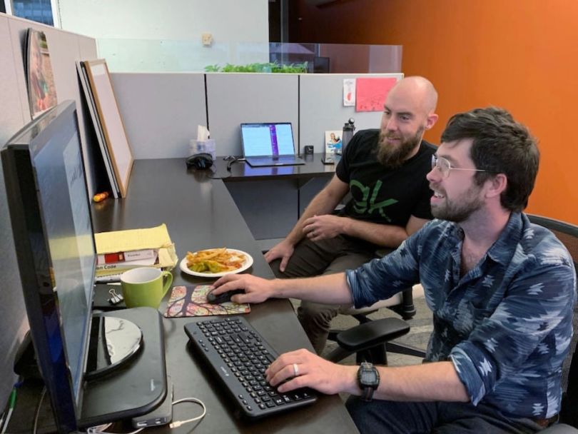 GreenKey Technologies team members working at a computer