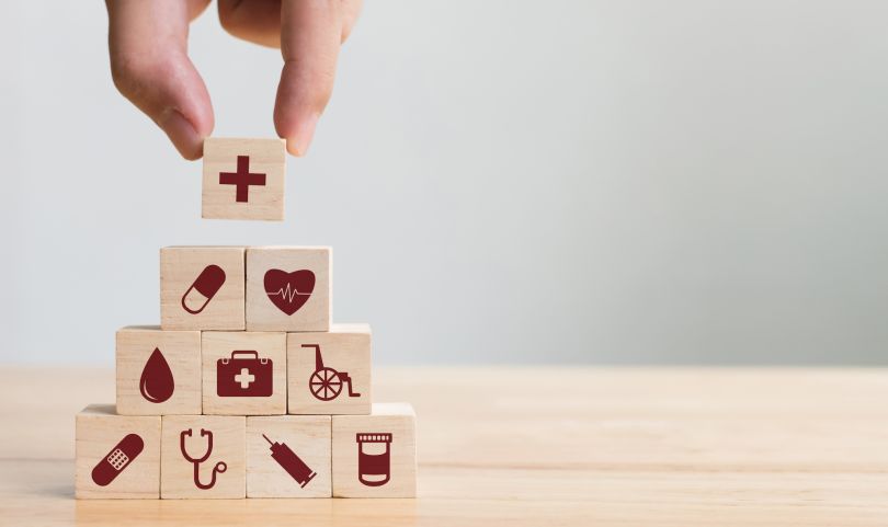 An image of blocks with medical symbols is pictured.