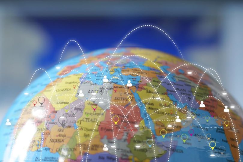 A globe with dotted lines connecting icons representing individuals in different regions.&nbsp;
