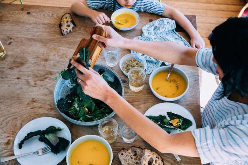 A family gathers around the table for a meal provided by Good Eggs.