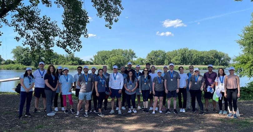 ICapital group photo outside with a lake in the background