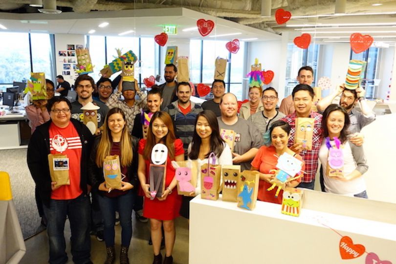 A group of Cie employees pose in the office together after a team celebration.