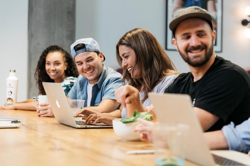 A group of employees at ChowNow talking during a meeting.