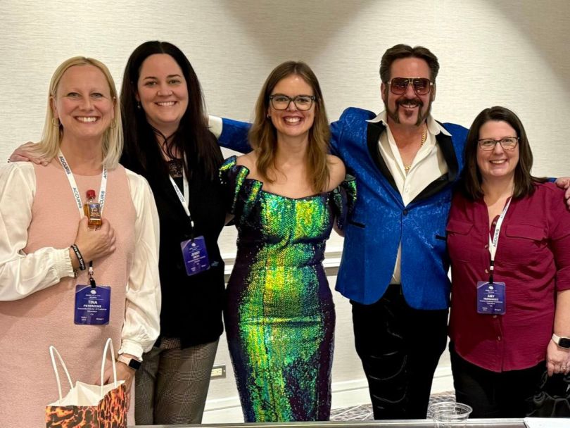 Vice President of Customer Experience Megan Fehn and four of her colleagues pose for a photo during a company event