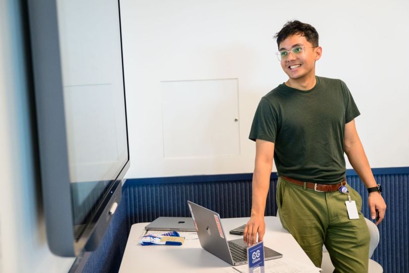 A CarGurus employee gives a presentation in front of colleagues in the office