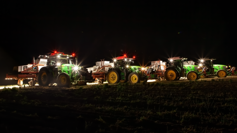 A fleet of Carbon AutoTractors photographed during night