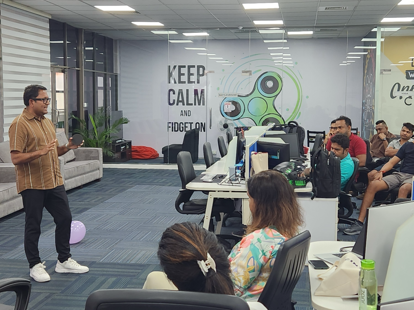 Cin7 CEO Ajoy Krishnamoorthy presents in front of a group of employees in Sri Lanka