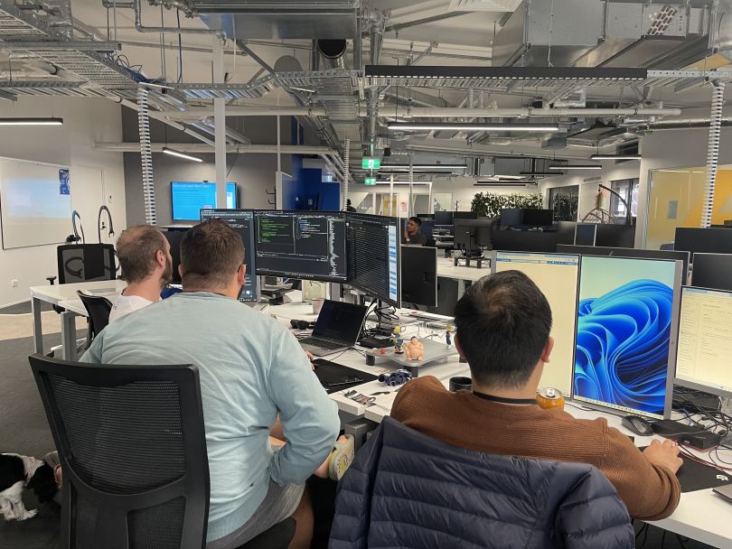 Three Cin7 software engineers work together while participating in a hackathon in the company’s New Zealand office