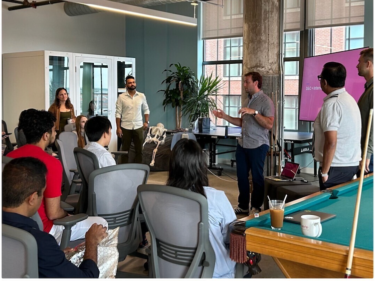 Cohere Health team members listen to a colleague give a presentation in the company’s office