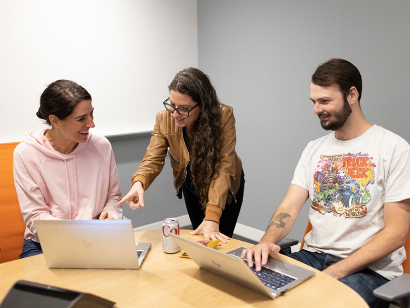 core digital media meeting in progress with three employees
