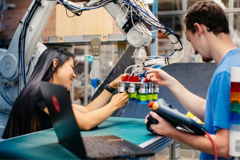 Two Covariant employees work together on a project.