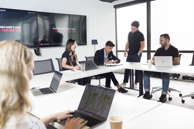 A group of Devbridge employees work on a project.