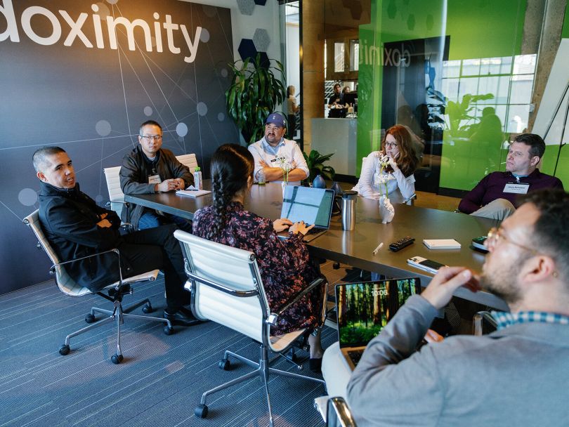 Clinicians hold a discussion in a conference room during the Doximity Conference