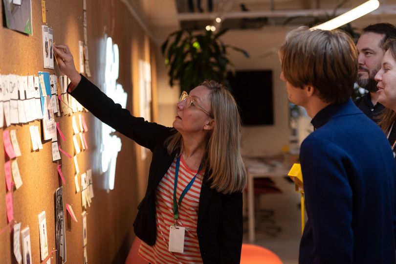 An Ericsson employee pointing to a whiteboard. 