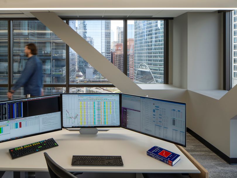 An image of a trading desk, which sits next to a window overlooking downtown Chicago, inside the firm’s office