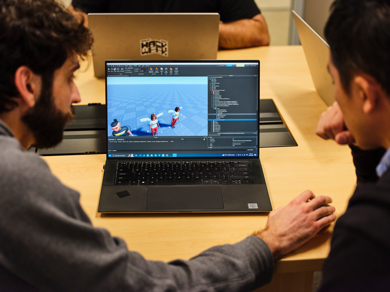 Two developers working in the Roblox platform on a laptop screen&nbsp;