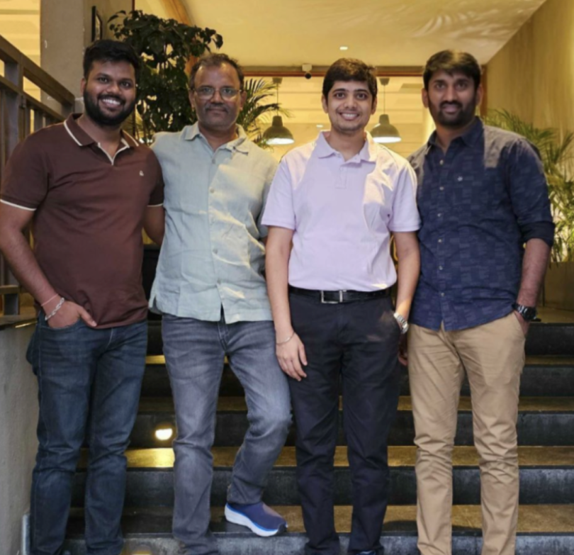 Sakthivel Muniraju poses for a photo with three other team members on a staircase