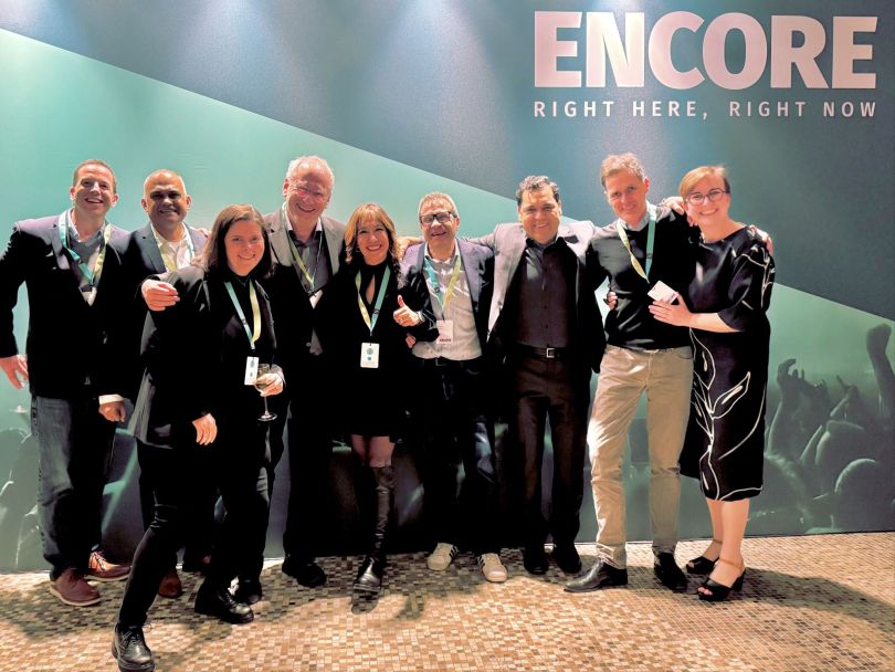 Nine HERE Technologies team members pose for a group photo during the company’s Ignite event