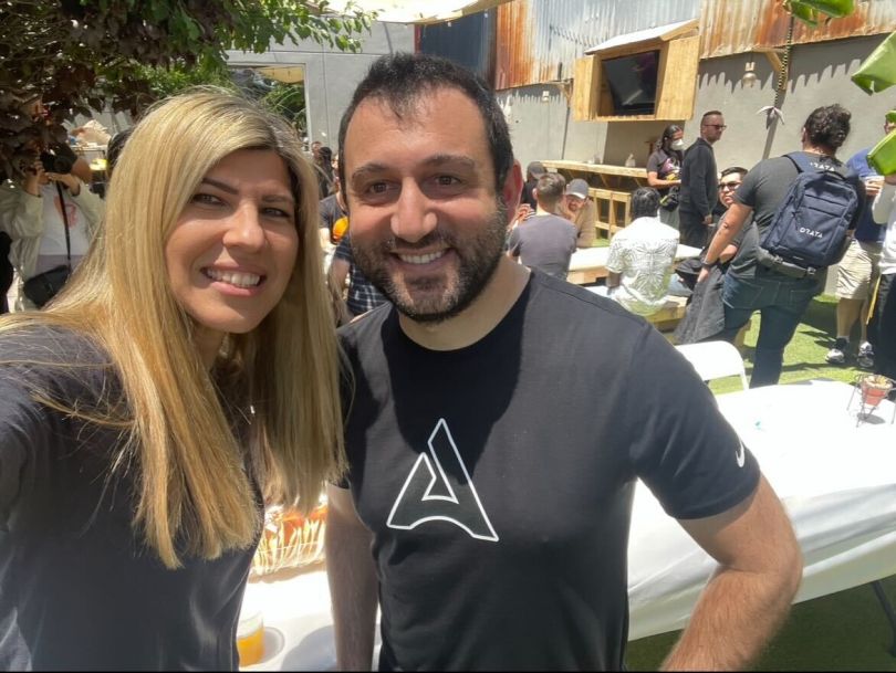 Two colleagues pose for a selfie at an event setup