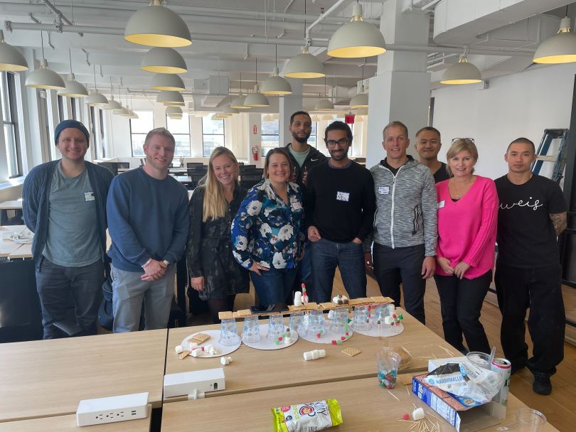 A group of employees pose during a group activity.