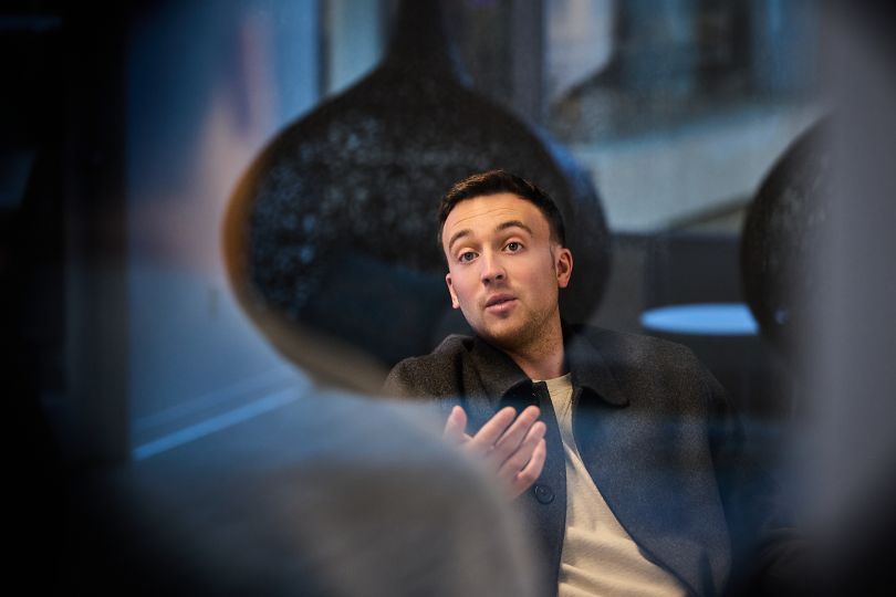 A Kensho employee speaks with a colleague in the company’s office