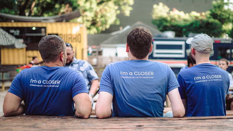 The backs of three ClosedLoop employees, wearing shirts that read “I’m a Closer”&nbsp;