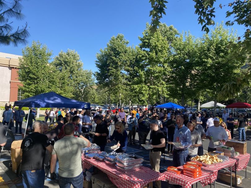 Pennymac team members enjoying food at a company-hosted barbecue