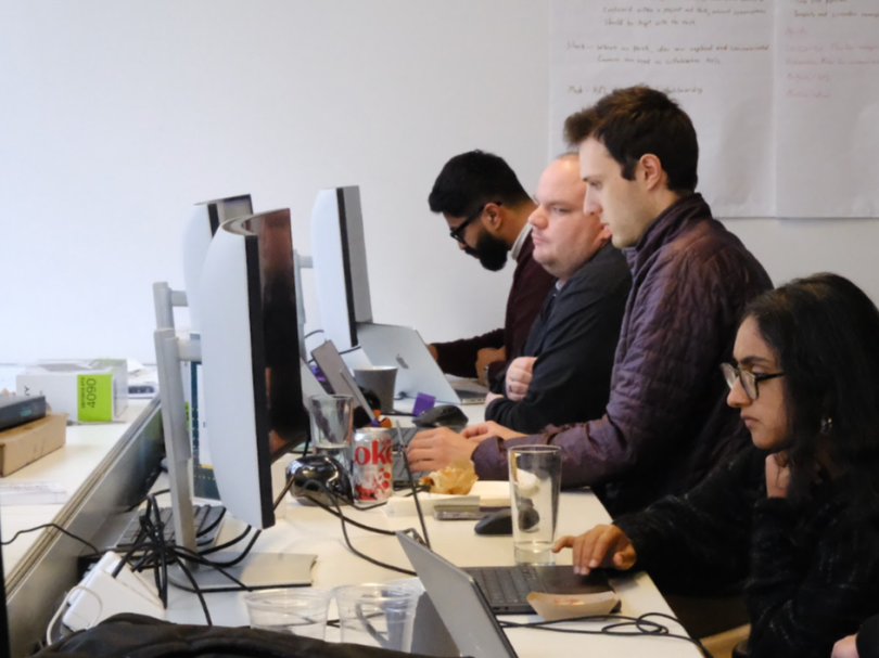RunPod team members working at their computers in the company’s office