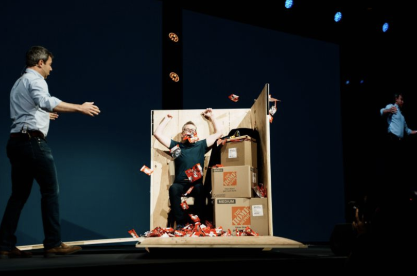 A Samsara teammate jumps out of a shipping crate full of KitKats at a Beyond event.