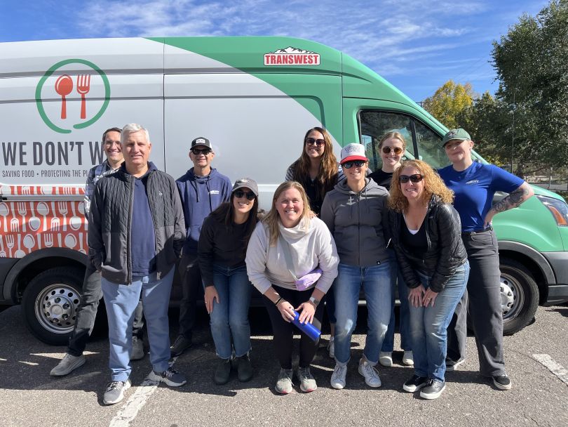 Scaled Agile team members posing for a group photo while volunteering with We Don’t Waste