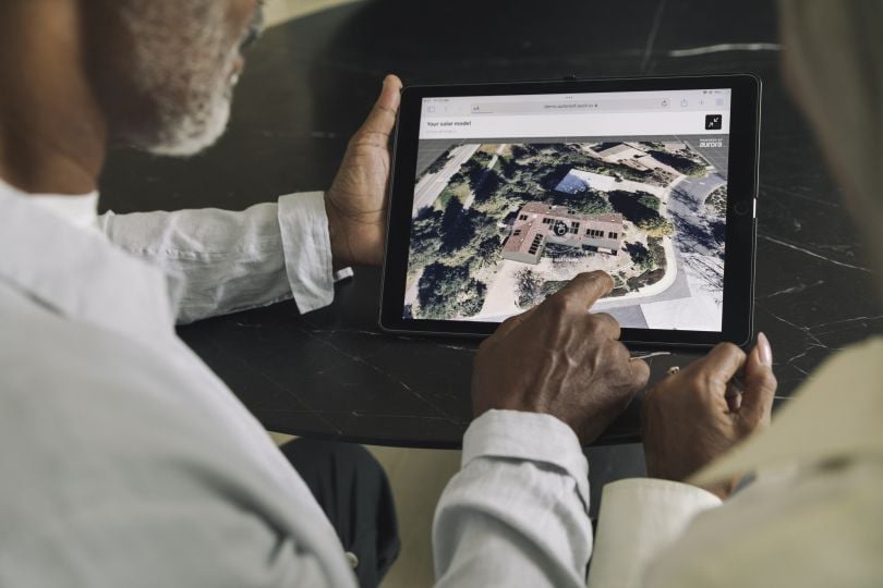Two individuals using Aurora Solar’s Lead Capture AI technology.