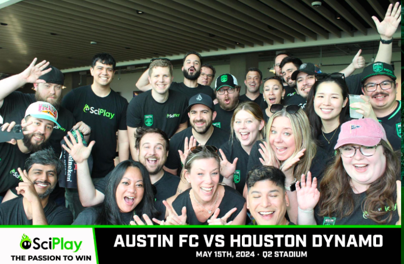 Several SciPlay team members posing for a group photo at Q2 Stadium