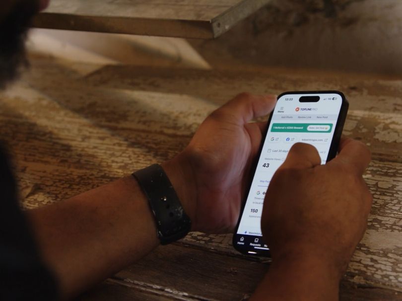 An individual searches through Topline Pro’s platform on their mobile device