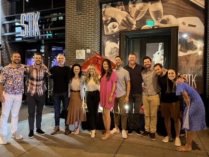 Udemy team  members standing together outside of a restaurant
