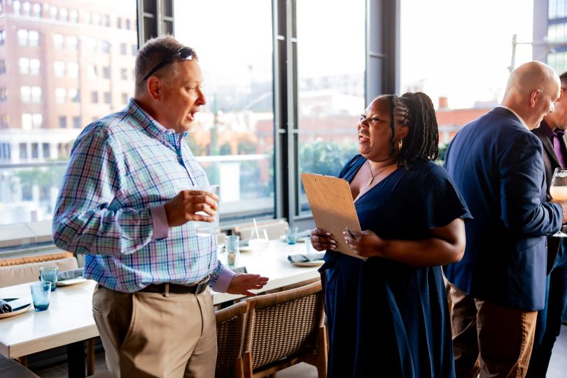 Devin Johnson networking with executives at a Game Changers Executive Dinner last summer.