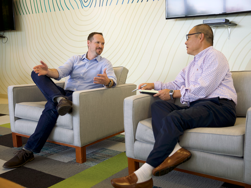 Fisher Investments talk in their office. 