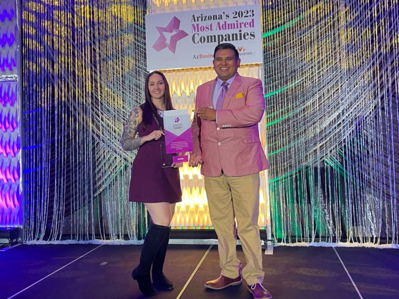 Nicki Legge receives an award on stage at Arizona’s 2023 Most Admired Companies awards ceremony.