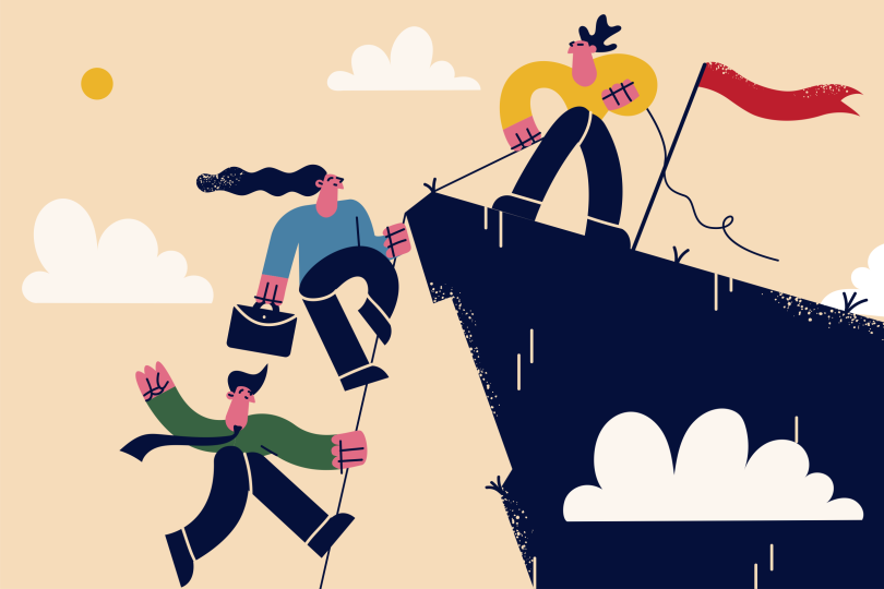 person pulling up others over a cliff with rope