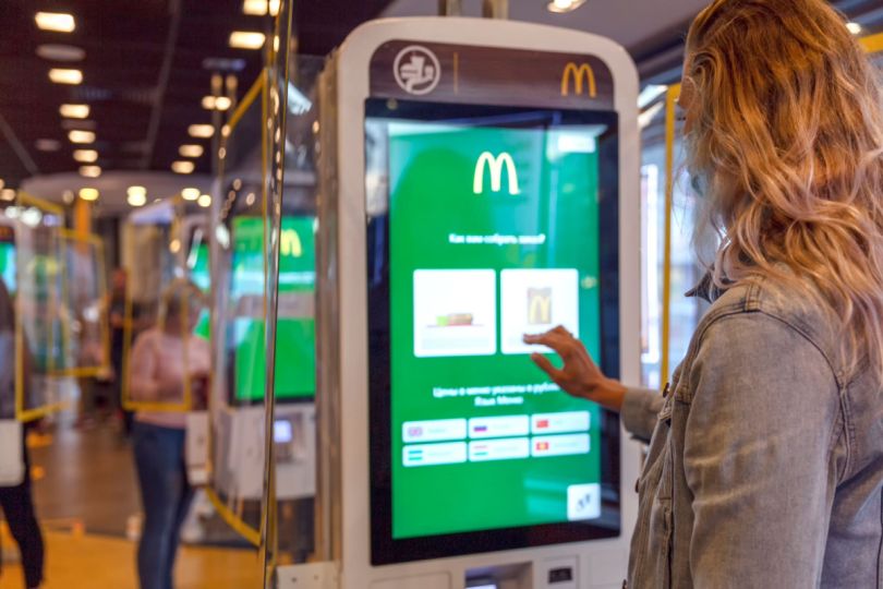 A customer orders a meal on a touch screen menu.&nbsp;
