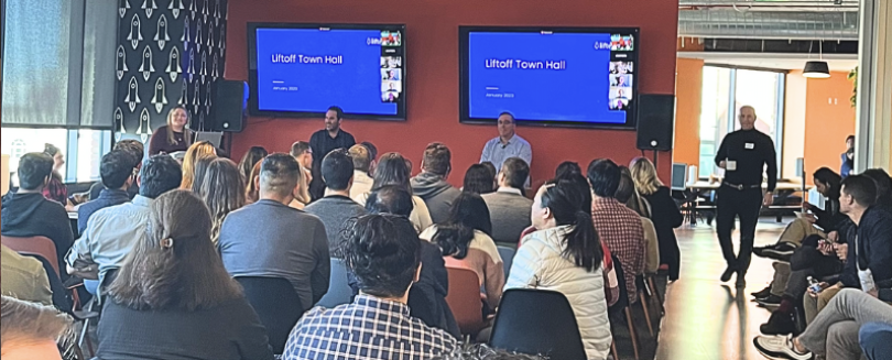 Photo of Liftoff town hall session, looking at presenters from behind seated audience