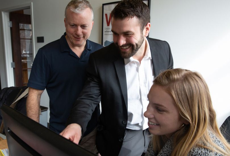 ktMINE staff laughing at a computer