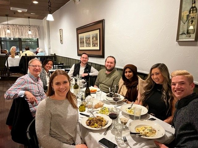 Leyton team members gather around a table. 