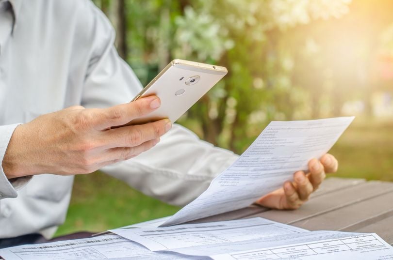 Stock footage of someone paying a bill through a mobile payment app