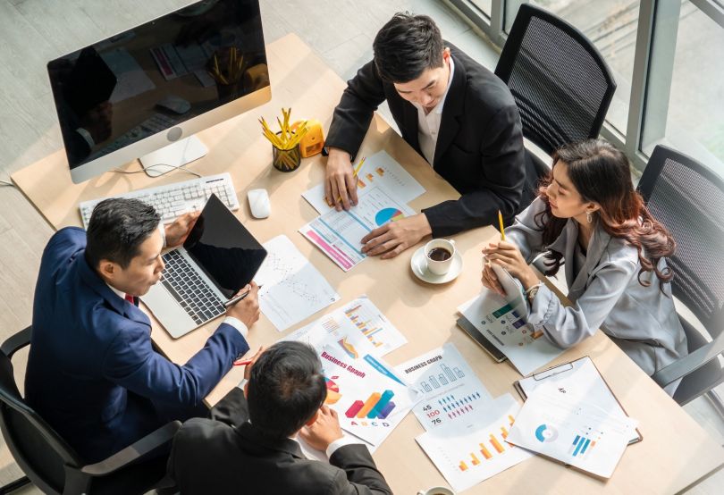 Office workers are pictured having a meeting.